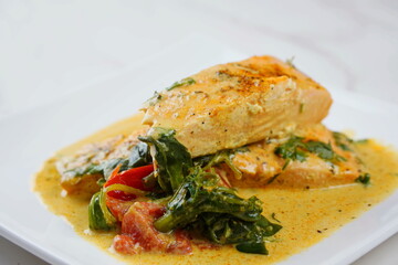 Salmon Fillet with spinach and cherry tomatoes in creamy sauce