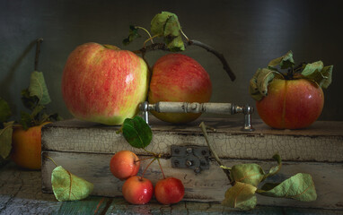 Ripe and tasty apples and an old wooden box. Still life.