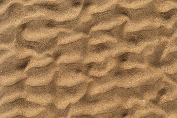 Texture of beach sand washed by the sea with ripple.