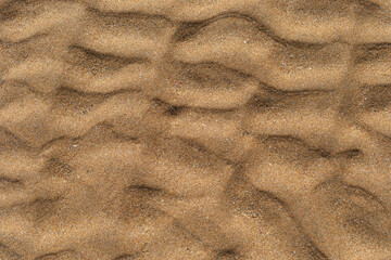 Texture of beach sand washed by the sea with ripple.