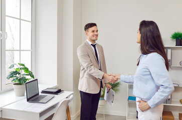 Obraz premium Business handshake happy man, woman negotiating best deal, entrepreneurs in agreement hand shake for effective competitive and collaborative situation, achieving mutually beneficial result, greeting