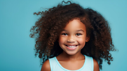 Portrait of smiling cute African American child girl with perfect skin, light blue background, banner.