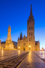 Old historical fortress and church in sunrise. City panorama at dusk. Sight on the Danube...