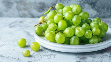 Juicy green grapes on a white plate