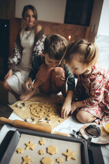 Mom with children cooking in the kitchen