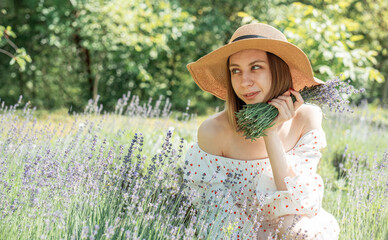 Young beautiful woman picking lavender flowers.