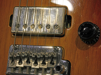 Vintage six-string wooden electric guitar with large pickup and knob for volume © ChiccoDodiFC