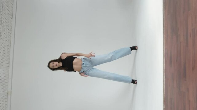 Woman in mid-dance, striking a dynamic pose against a plain background, exuding confidence and grace. Concept: Highlighting the importance of maintaining an active lifestyle and celebrating the