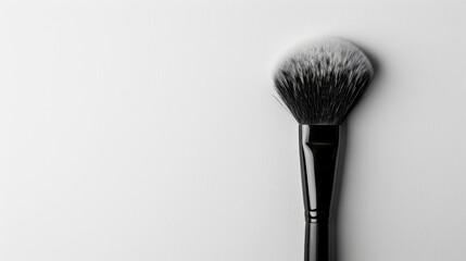 Makeup brush in contrast on white surface