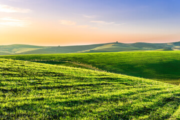 green spring or fummer farm field. rural landscape of countryside wirh agriculture view in farmland with beautiful cloudy sky on background