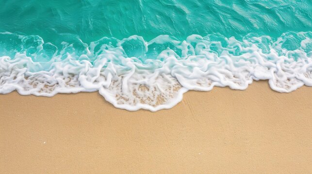Serene top view of sand beach and sea waves, ideal for summer vacation and travel concepts.