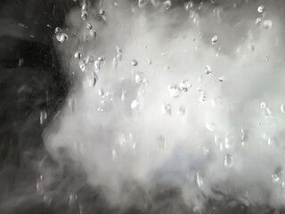 An Abstract Image of white steam with water droplets as background.