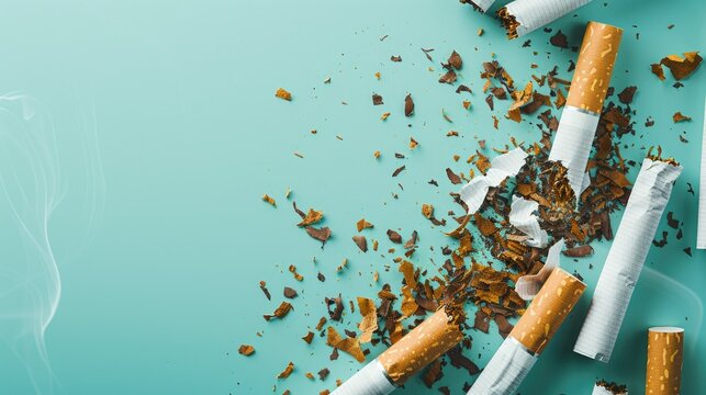 STOP smoking message with broken cigarette and tobacco on light blue background