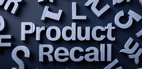 3D wooden letters spelling "Product Recall" on dark background with scattered letters. Consumer safety, quality control, product liability, recall notification, manufacturing issues.