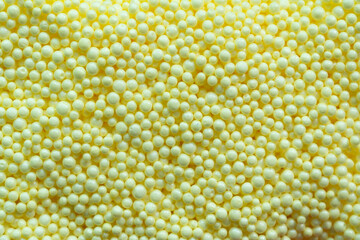 close up of yellow foam beads for the background