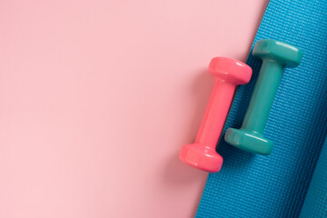 dumbbell and blue yoga mat on table, fitness healthy and sport concept
