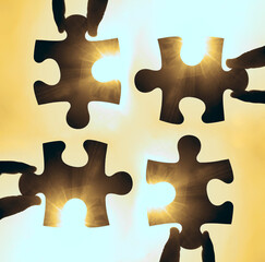 two hands of businessman to connect couple puzzle piece with sky background.Jigsaw alone wooden...