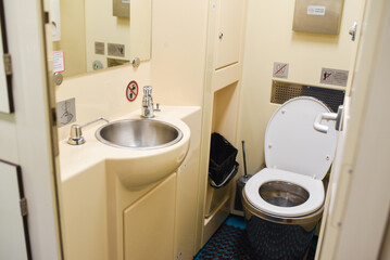 toilet room on a long-distance train. composting toilet, sink and toilet on the train.