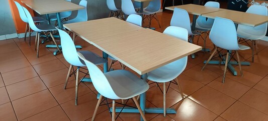Empty tables and benches in a restaurant.