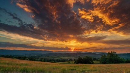 Obraz premium Vibrant sunset with dramatic clouds and silhoutte