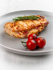 Grilled chicken breast with rosemary and cherry tomatoes