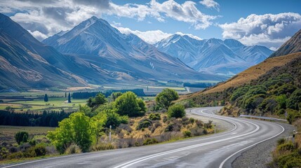 Naklejka premium A mountain road with sharp curves and scenic views of valleys and peaks