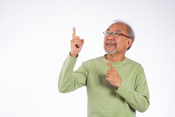 Portrait Asian grey haired with glasses senior man point index fingers to space studio shot isolated on white background, elderly old man pointing finger up