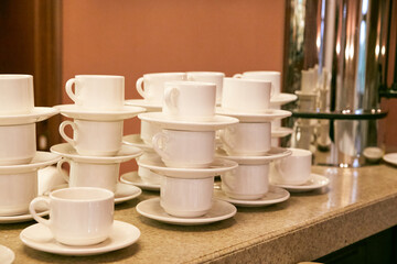 white cups and saucer on the bar counter