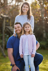 Fototapeta premium Man, woman and girl with portrait in garden for holiday, together in England with smile. Happy family, outdoor and solidarity for vacation or travel with love, wellness or support in adventure park