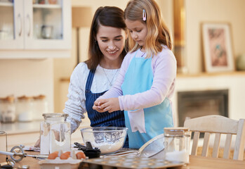 Happy mother, daughter and baking with eggs or flour in kitchen for dessert, snack or mixing...