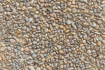 Beautiful texture of a wall or a path with gray and color smooth stones