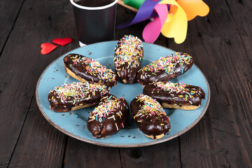 Chocolate Eclairs with Powdered Sugar on Rustic Plate: Homemade French Pastries Served with Coffee, Gourmet Dessert Photography on Dark Wooden Table