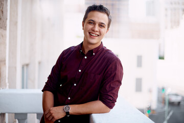 Portrait, man and balcony with smile as junior or intern financial advisor for insurance company....