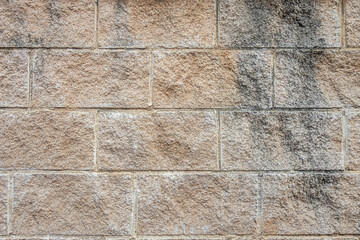abstract background of beige stone lined old wall close up