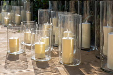 Wedding decoration with candles in the garden with green grass.