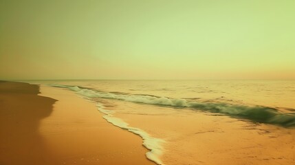 Obraz premium The sky is clear and the beach is quiet The sea shines in an orange light