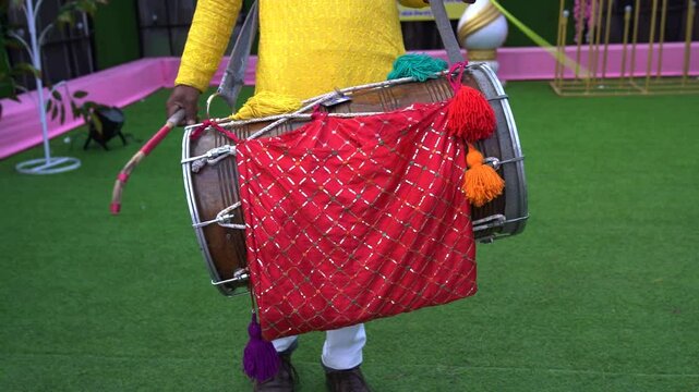 Drummer playing big drum in wedding or festival, men plays a drum as a musical instrument.