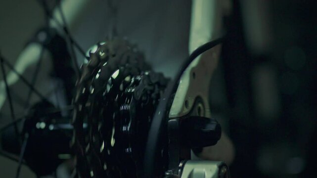 Macro shot of a bicycle mechanism with chain and sprockets. The movement of the chain rotating the sprockets and wheel. The modern bicycle is used as an environmentally friendly way of transportation