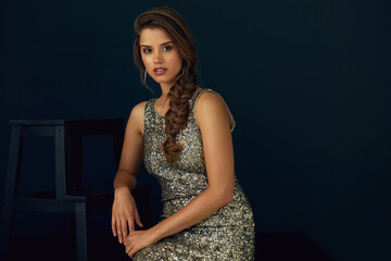 Fototapeta premium Sequin, fashion and portrait of woman with confidence in designer clothes, elegant style or pride. Model, person and glitter gown with makeup, beauty or glamour with mockup space on studio background