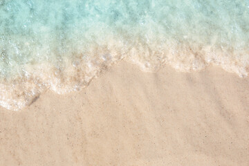 Sea waves rolling on beautiful sandy beach, top view. Summer vacation