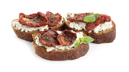 Delicious ricotta bruschettas with sun dried tomatoes and basil isolated on white
