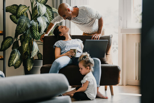 Happy family relaxing at home with technology