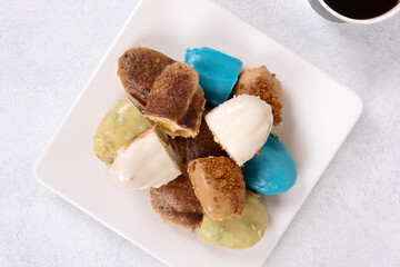 Assorted Eclairs in Vibrant Colors: A Delightful and Colorful Pastry Display