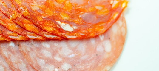 A close up of a slice of chorizo and salchichon