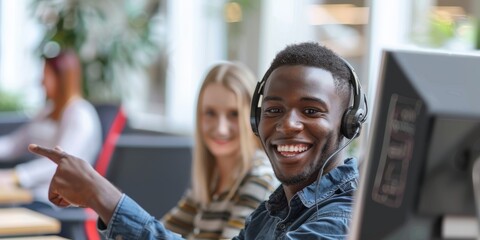 Mixed-race dude contact center telemarketing agent discussing plans with workmate on computer in office. Troubleshooting customer service and sales support with two consultants