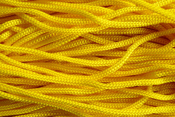 a yellow textile cord is laid out horizontally on the surface