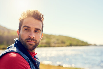 Man, thinking and relax by lake in nature for scenery, sightseeing or travel location with space....