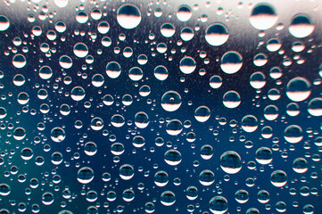 Clear water droplets with blue color background. Nature beauty concept