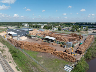 Wood sawmill, machinery for processing wood. Processing plant. A worker operating loader, modern...