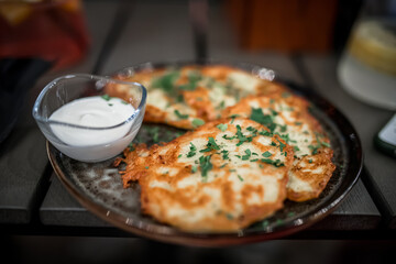 Potato pancakes with sour cream and parsley